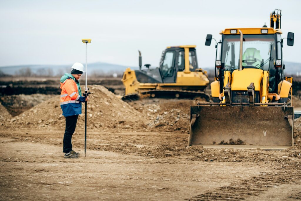 Construction industry details with surveyor using GPS system and total station. Engineer and geodesy